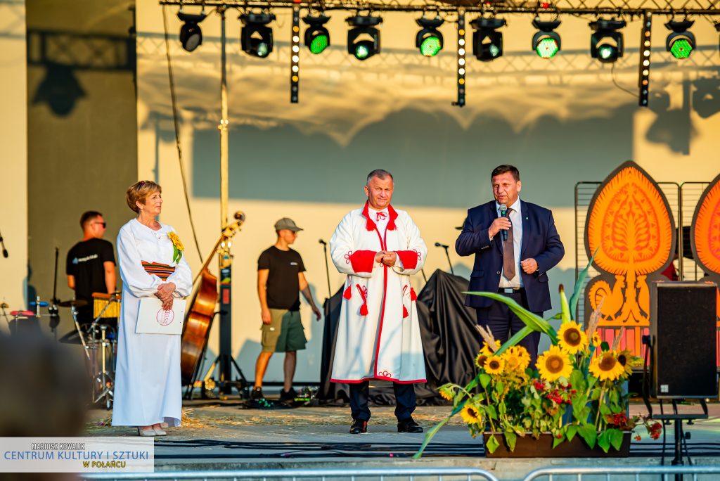 Na scenie Wicewojewoda Świętokrzyski Michał Skotnicki przemawia do mikrofonu, na scenie towarzyszą mu burmistrz Miasta i Gminy Połaniec oraz konferansjerka. Wicewojewoda